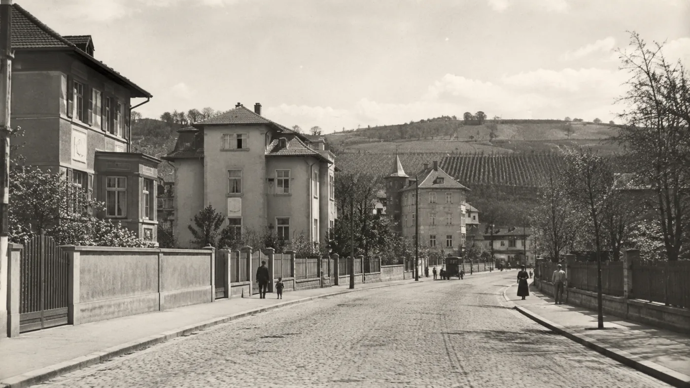 Period view of a street in Prague's Rokoska with villas and vineyards on the slope